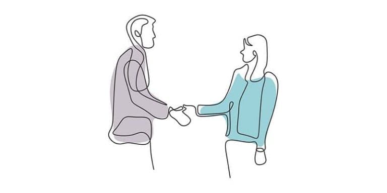 Imagen de una pareja dándose la mano en un acuerdo de separación mutua.